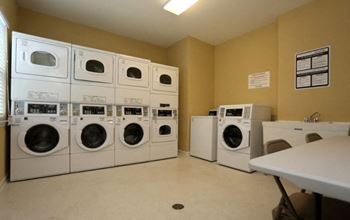 A laundromat with rows of washers and dryers.
